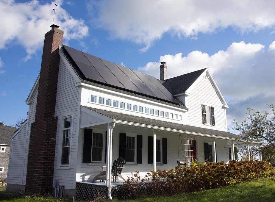 a farmhouse with solar panels installed