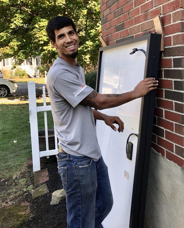 an installer unpacking new solar panels